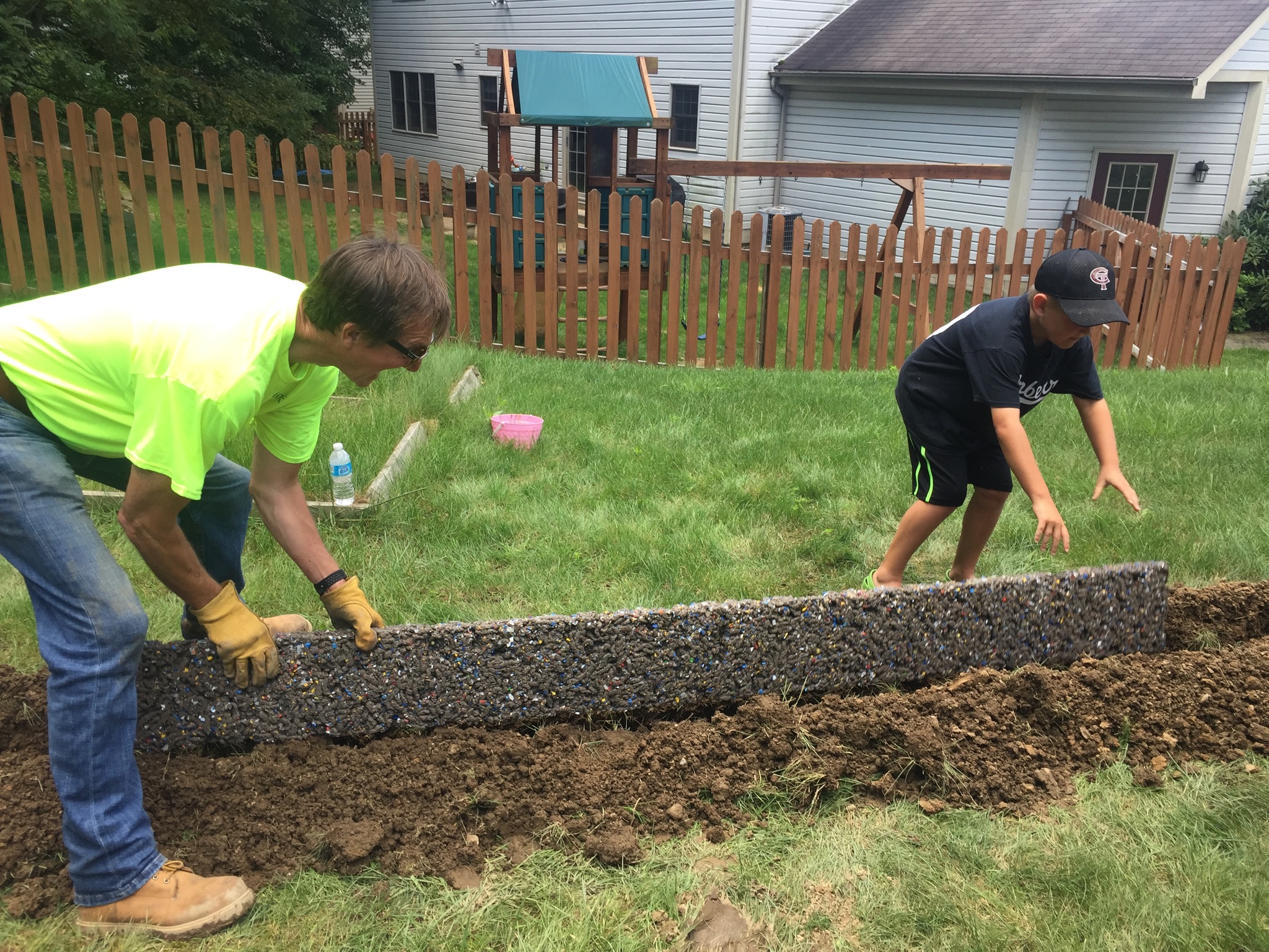 Hydro Fix crew installing pressure-fed drainage system in residential backyard Metro Atlanta Georgia